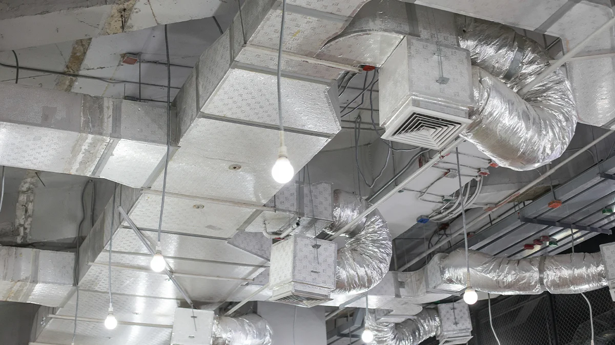 Technician from Rightway A/C & Refrigeration performing duct work installation.