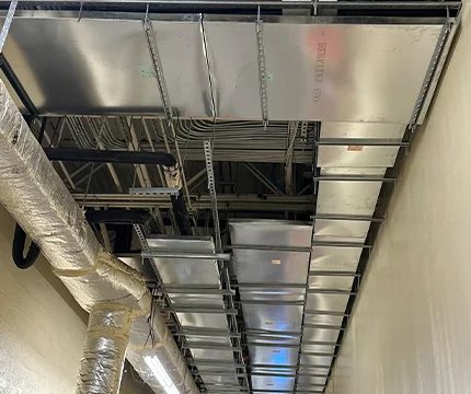 Expert inspecting duct work to ensure optimal air flow and system performance.