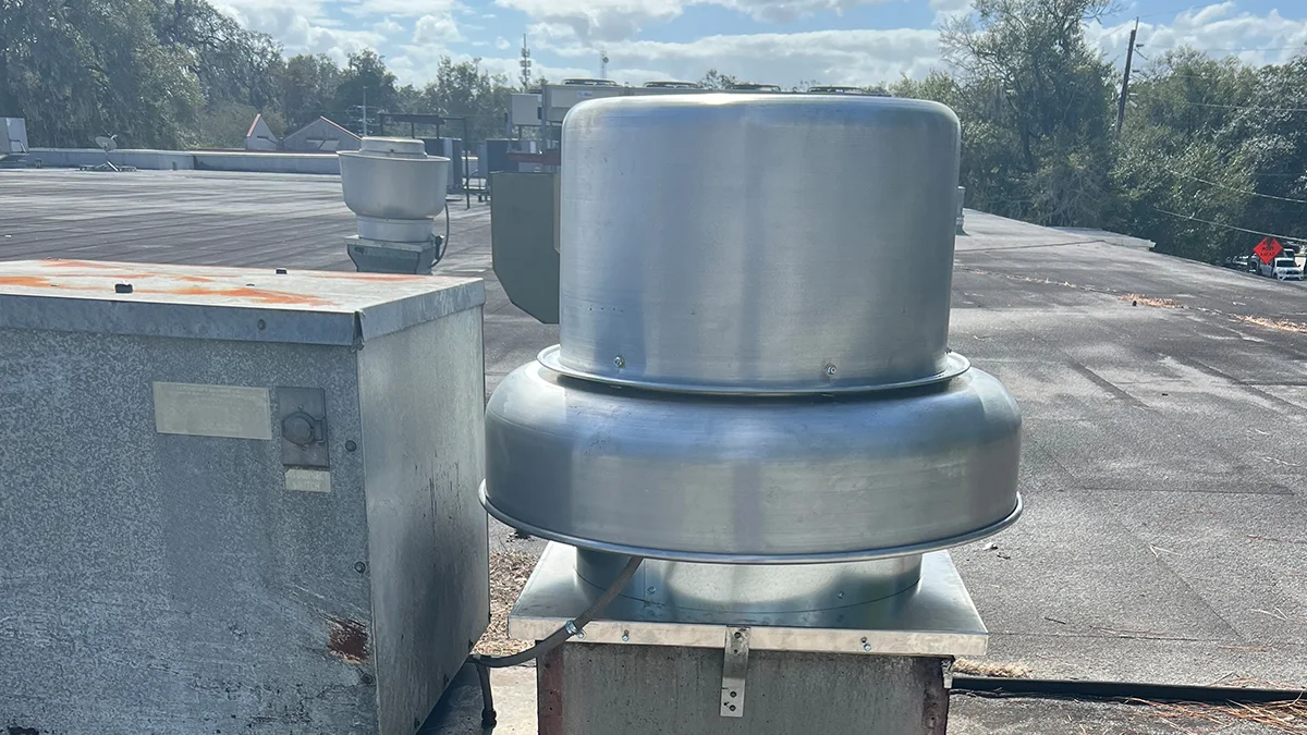 Technician from Rightway A/C & Refrigeration servicing a large exhaust fan.