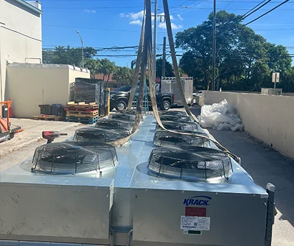 Expert from Rightway A/C & Refrigeration inspecting refrigeration systems in a new building.