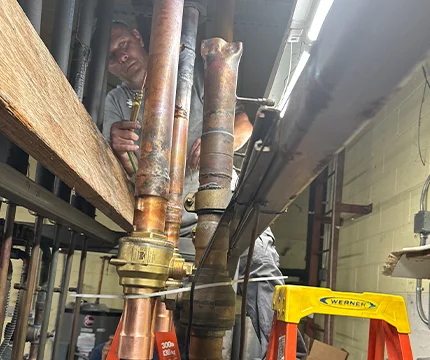 Expert inspecting pipe fittings to ensure reliable system performance.