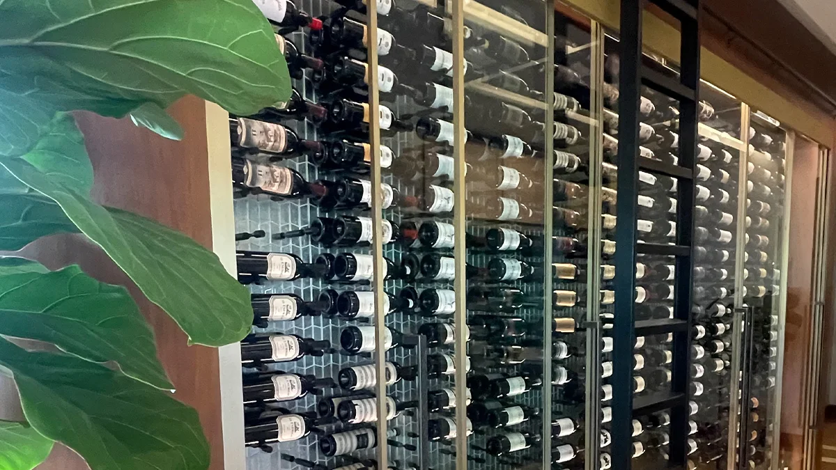 Technician from Rightway A/C & Refrigeration servicing a wine cellar for temperature control.